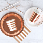 Rose gold foil cups with stripes on plates and straws birthday theme from Parte Haus party supply store in Bethesda MD