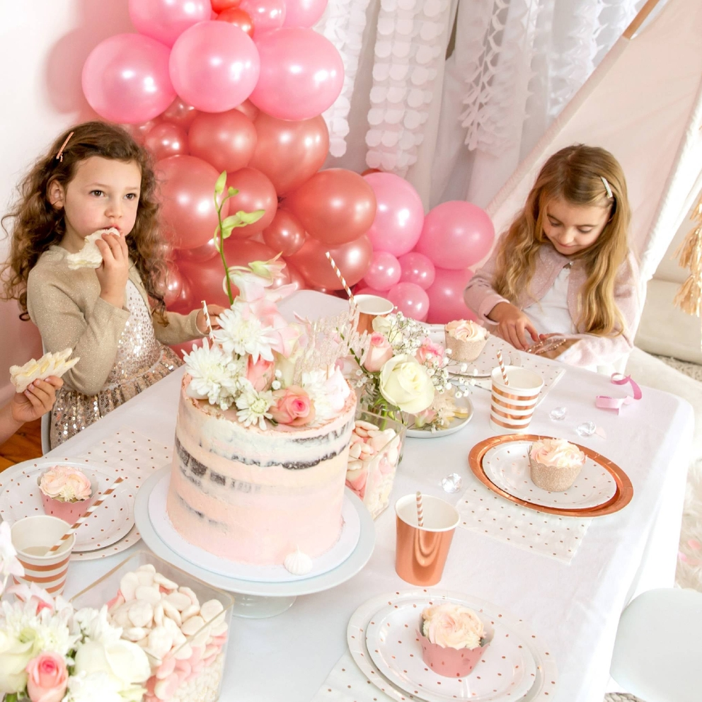 Rose gold foil cups with stripes on kids birthday table setting from Parte Haus party supply store in Bethesda Maryland