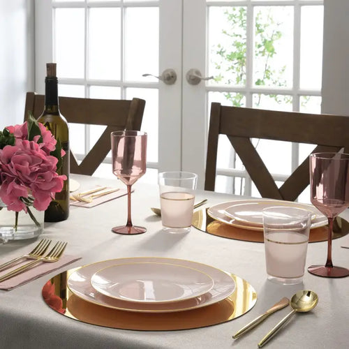 Blush gold plastic plates elegant dinner table setting for celebration from Parte Haus party supply store in Bethesda Maryland
