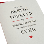 White friendship greeting card with black and red text and a small heart for best friends from Parte Haus party supply store in Bethesda MD.