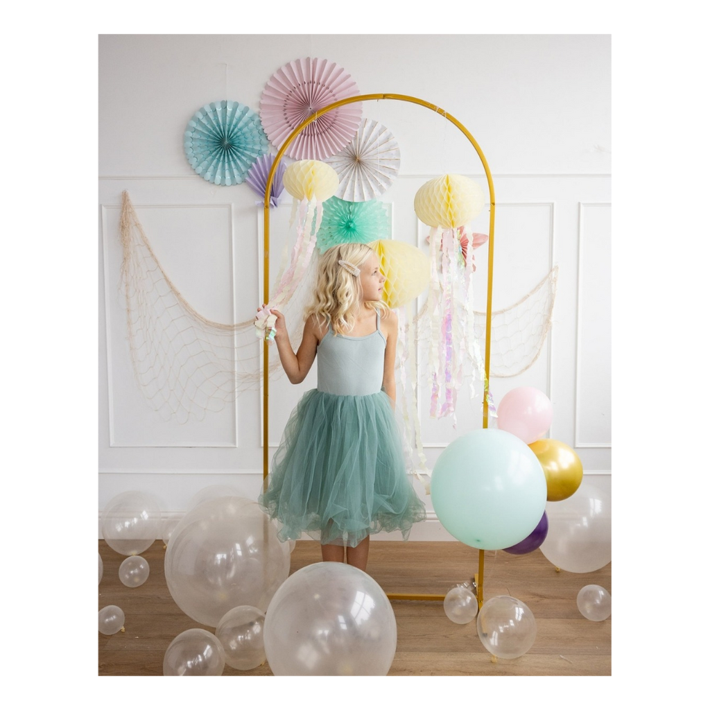 Mint dress girl standing with pastel balloons and fans for birthday from Parte Haus party supply store in Bethesda MD