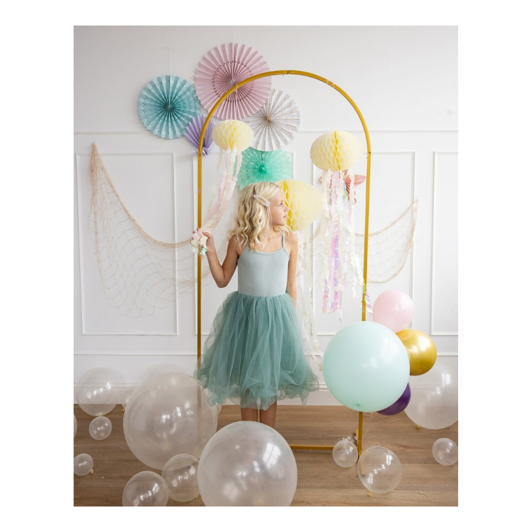 Mint dress girl standing with pastel balloons and fans for birthday from Parte Haus party supply store in Bethesda MD