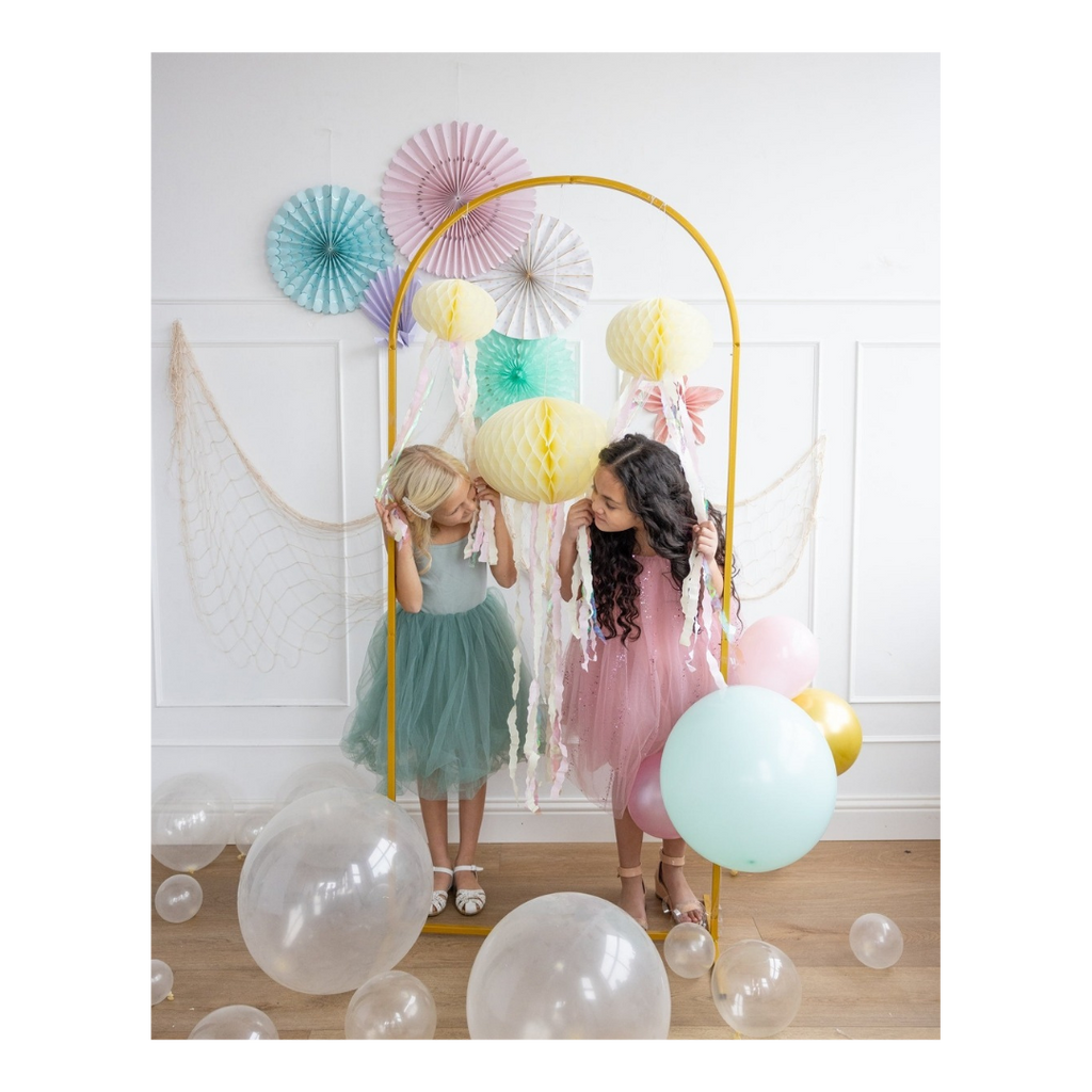 Pastel jellyfish decorations with girls in colorful dresses under arch for birthday from Parte Haus party supply store in Bethesda MD