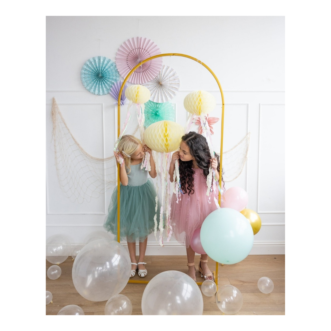 Pastel jellyfish decorations with girls in colorful dresses under arch for birthday from Parte Haus party supply store in Bethesda MD