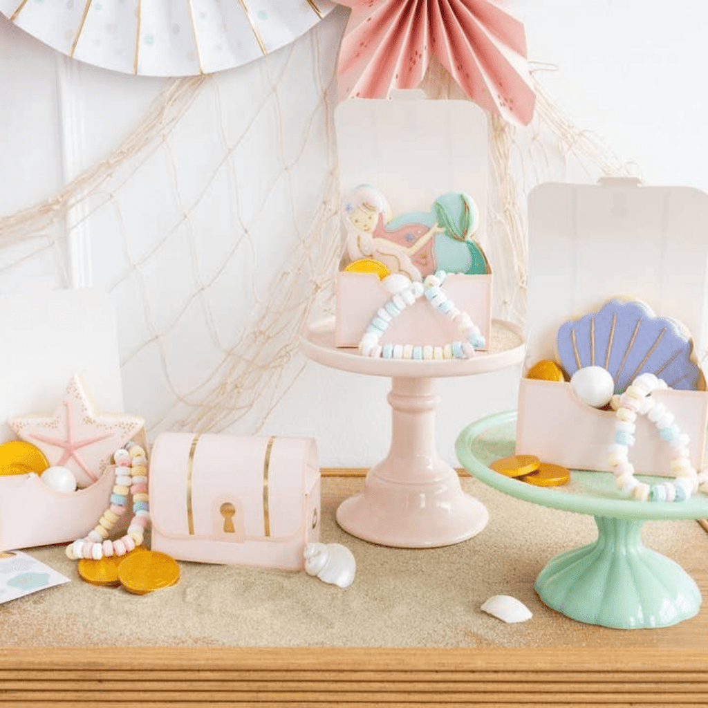 Pastel mermaid treasure chest favor boxes with seashell and candy bracelets under the sea theme from Parte Haus party supply store in Bethesda Maryland