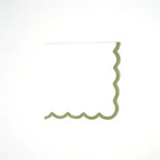 Green scallop cocktail napkin with wavy edges for celebrations from Parte Haus party supply store in Bethesda Maryland