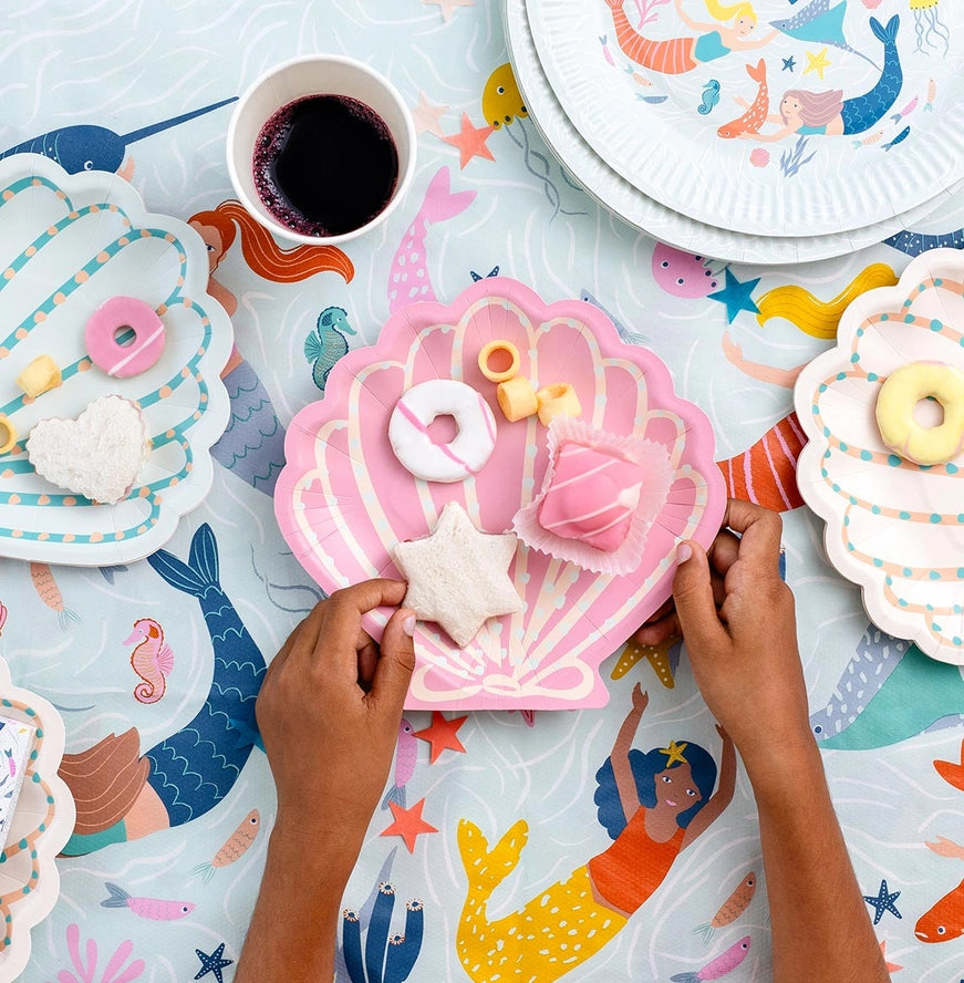 Pink shell shaped plates with treats mermaid birthday theme from Parte Haus party supply store in Bethesda MD