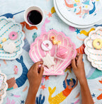 Pink shell shaped plates with treats mermaid birthday theme from Parte Haus party supply store in Bethesda MD