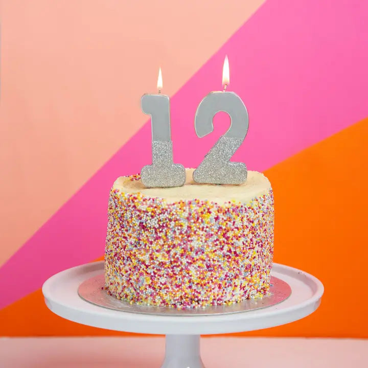 Silver glitter number candle on a birthday cake for celebration from Parte Haus party supply store in Bethesda Maryland
