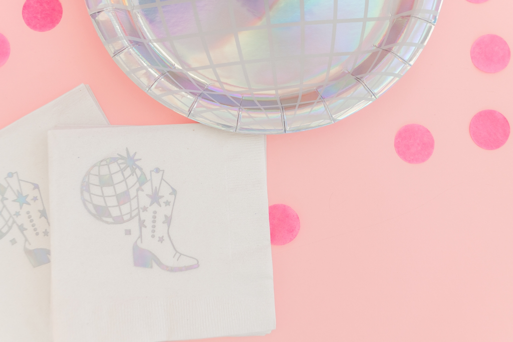 Silver holographic disco ball dinner plates with fun napkins for birthday celebration from Parte Haus party supply store in Bethesda MD