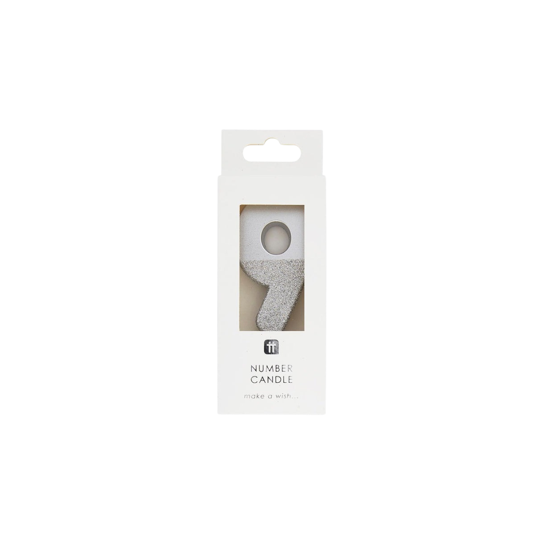 Silver number candle shaped as 9 in packaging for birthday from Parte Haus party supply store in Bethesda MD