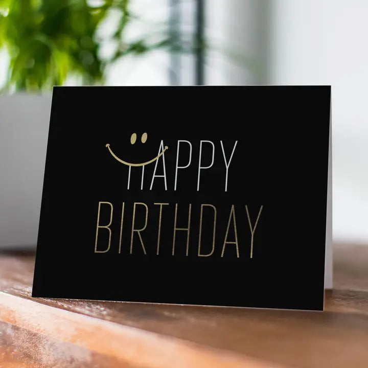 Black gold birthday greeting card with smiley face text for birthday theme from Parte Haus party supply store in Bethesda MD