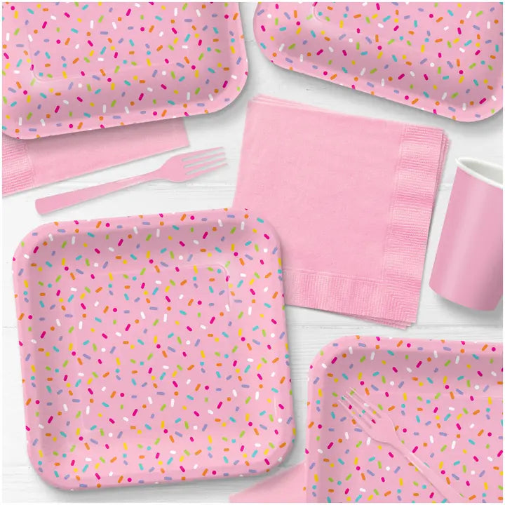 Pink sprinkle dinner paper plates with napkins and utensils for birthday from Parte Haus party supply store in Bethesda Maryland