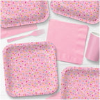 Pink sprinkle dinner paper plates with napkins and utensils for birthday from Parte Haus party supply store in Bethesda Maryland