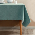 Green fabric tablecloth with scalloped edges for dining from Parte Haus party supply store in Bethesda MD