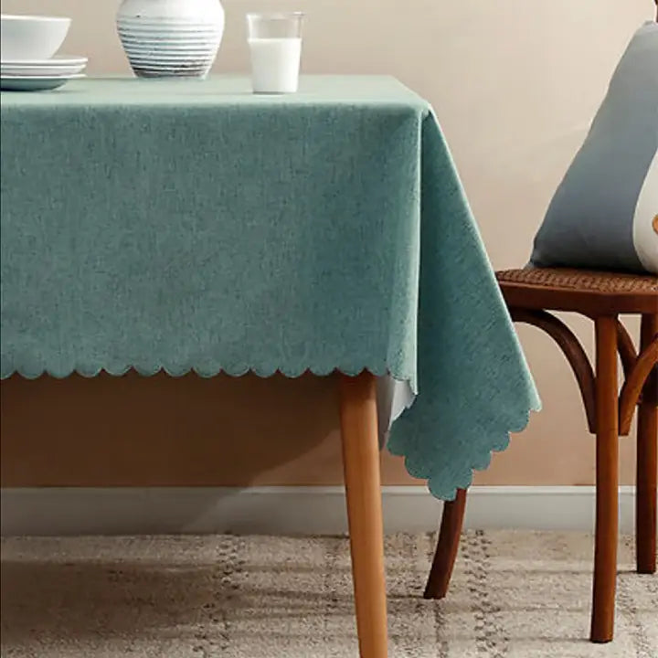 Blue tablecloth with scalloped edge on wooden table dining event from Parte Haus party supply store in Bethesda Maryland