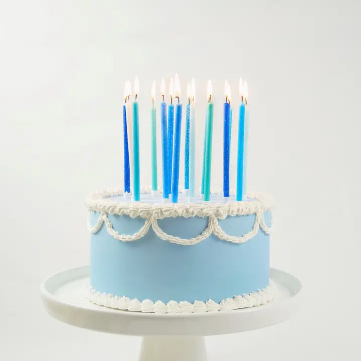 Tall blue gradient birthday candles on iced cake for birthday from Parte Haus party supply store in Bethesda MD