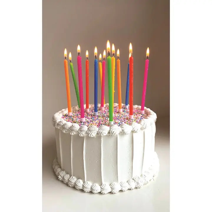 Neon rainbow gradient birthday candle set on white cake for birthday from Parte Haus party supply store in Bethesda Maryland