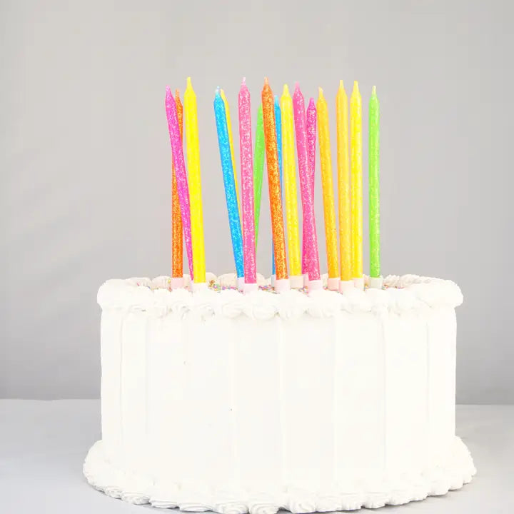 Neon rainbow gradient candle set tall colorful glitter birthday candles on cake for celebration from Parte Haus party supply store in Bethesda Maryland