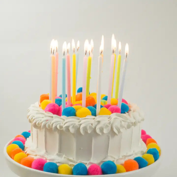 Pastel rainbow gradient candle set on birthday cake for celebration from Parte Haus party supply store in Bethesda Maryland
