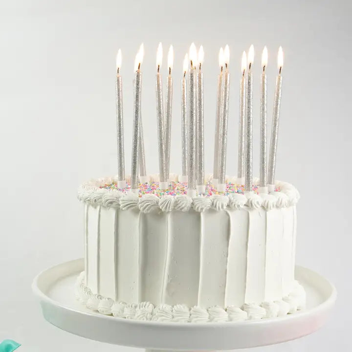 Silver glitter candles on a frosted birthday cake for birthday celebration from Parte Haus party supply store in Bethesda Maryland