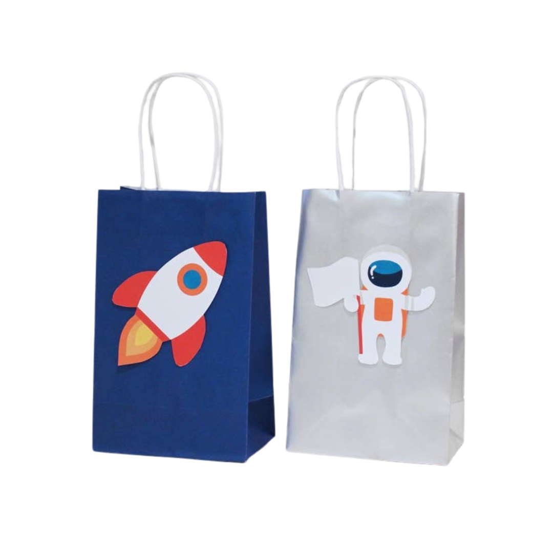 Blue rocket space gift bag and white astronaut gift bag for space birthday from Parte Haus party supply store in Bethesda MD.