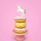 White unicorn cake topper candle on pink and yellow donuts for birthday from Parte Haus party supply store in Bethesda MD