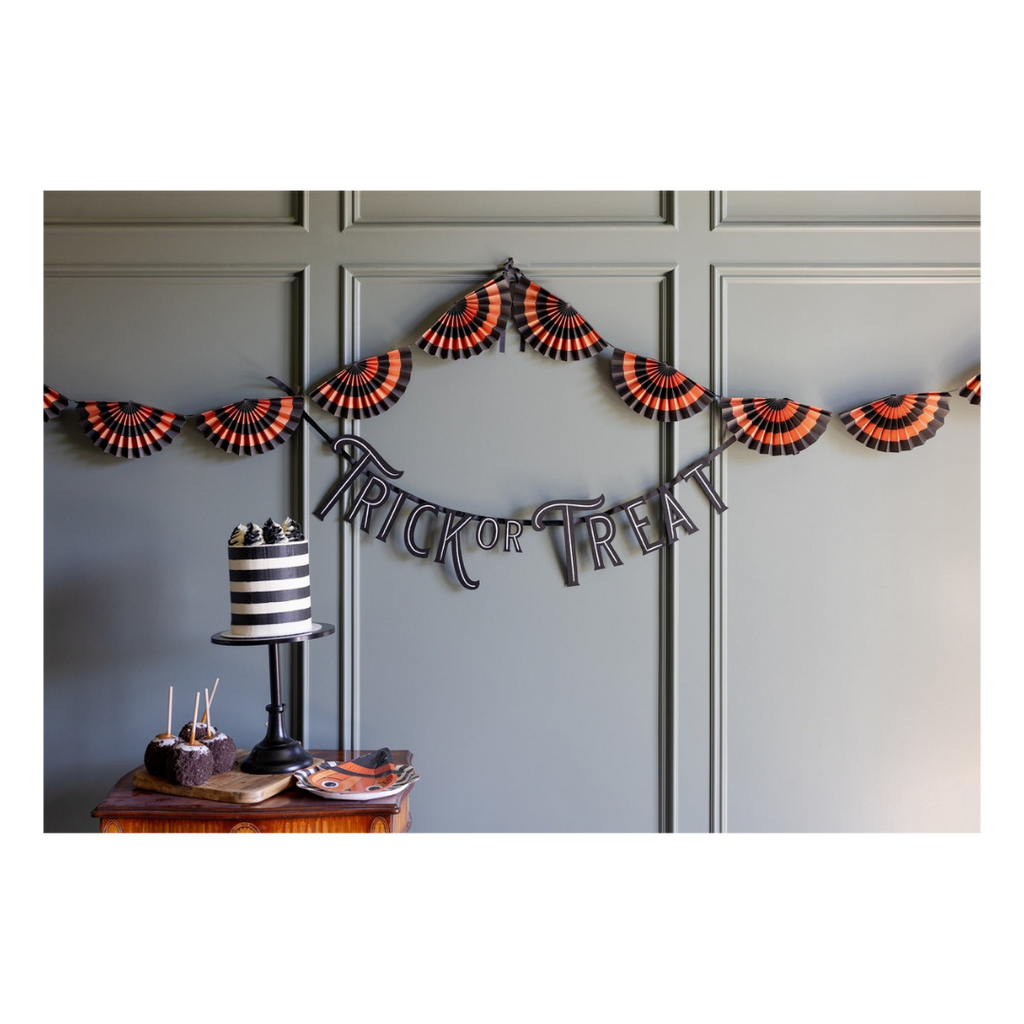Black and orange Halloween paper fan garland and Trick or Treat banner from Parte Haus party supply store in Bethesda MD