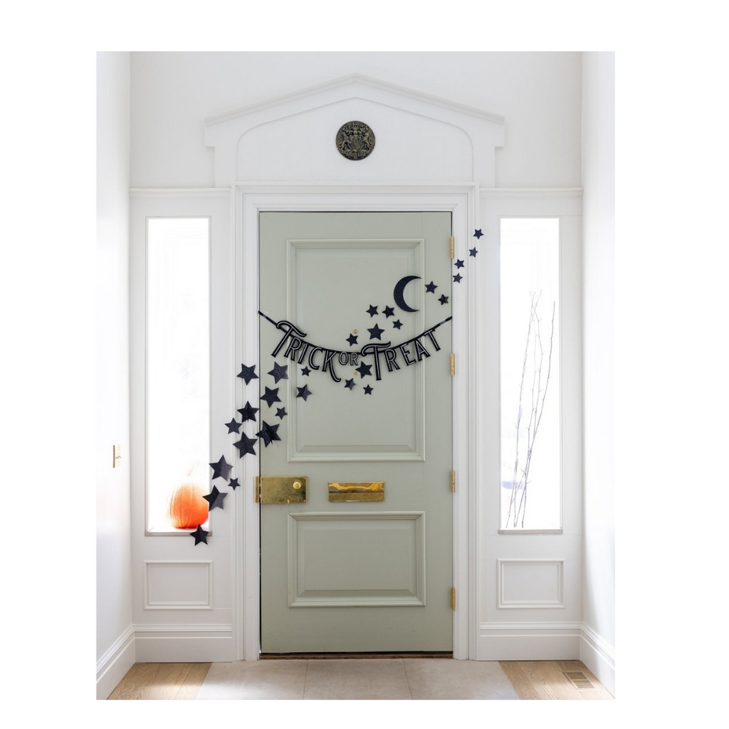 Black Halloween trick or treat banner with stars and moon wall decor from Parte Haus party supply store in Bethesda Maryland