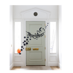 Black Halloween trick or treat banner with stars and moon wall decor from Parte Haus party supply store in Bethesda Maryland