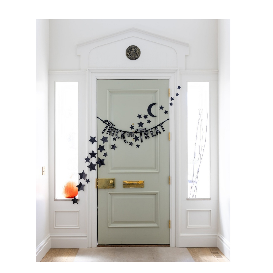 Black Halloween trick or treat banner with stars and moon wall decor from Parte Haus party supply store in Bethesda Maryland