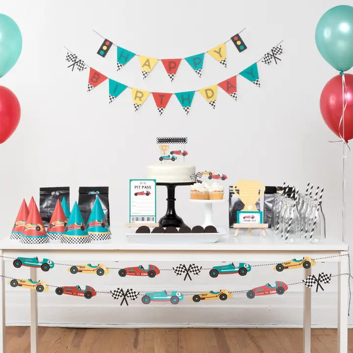 Multi color vintage race car birthday banner with checkered flags for race car theme from Parte Haus party supply store in Bethesda MD