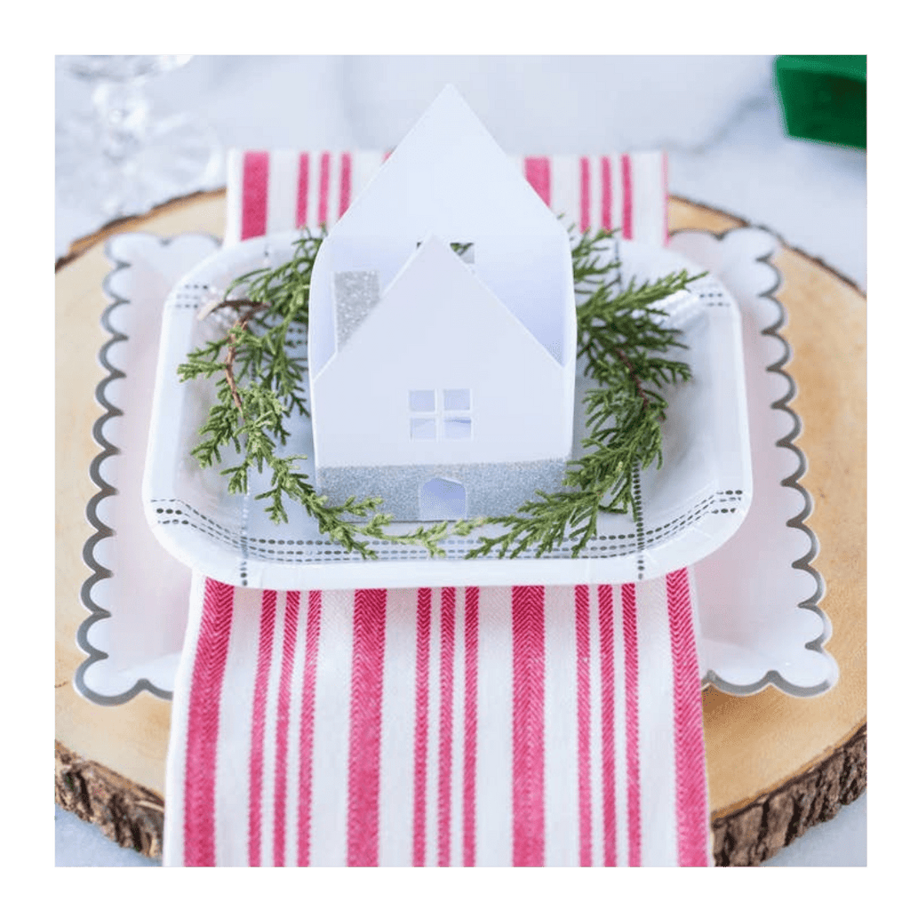 White and silver scalloped edge plate with mini house winter holiday decor from Parte Haus party supply store in Bethesda MD