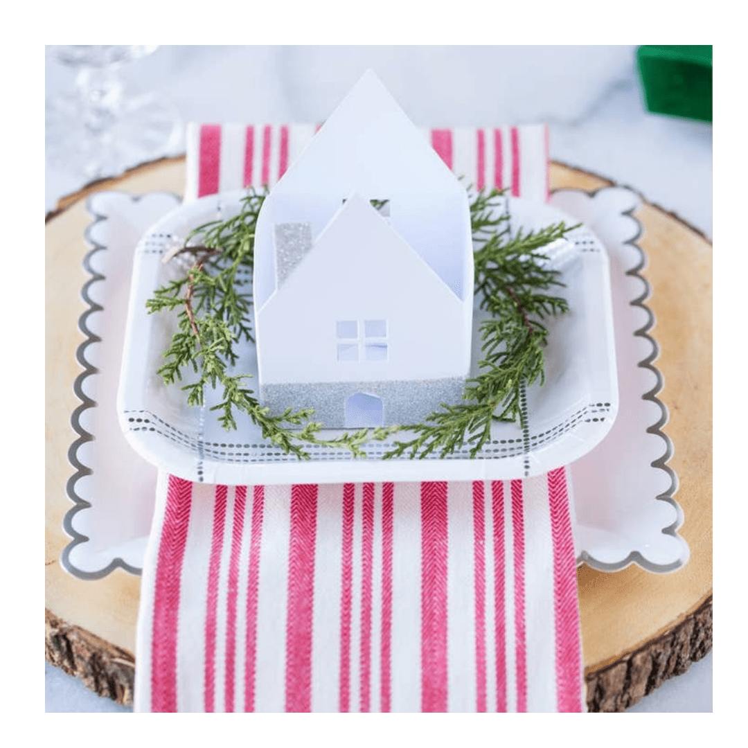 White and silver scalloped edge plate with mini house winter holiday decor from Parte Haus party supply store in Bethesda MD