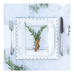 White scalloped paper plate with greenery and cinnamon stick holiday setting from Parte Haus party supply store in Bethesda MD