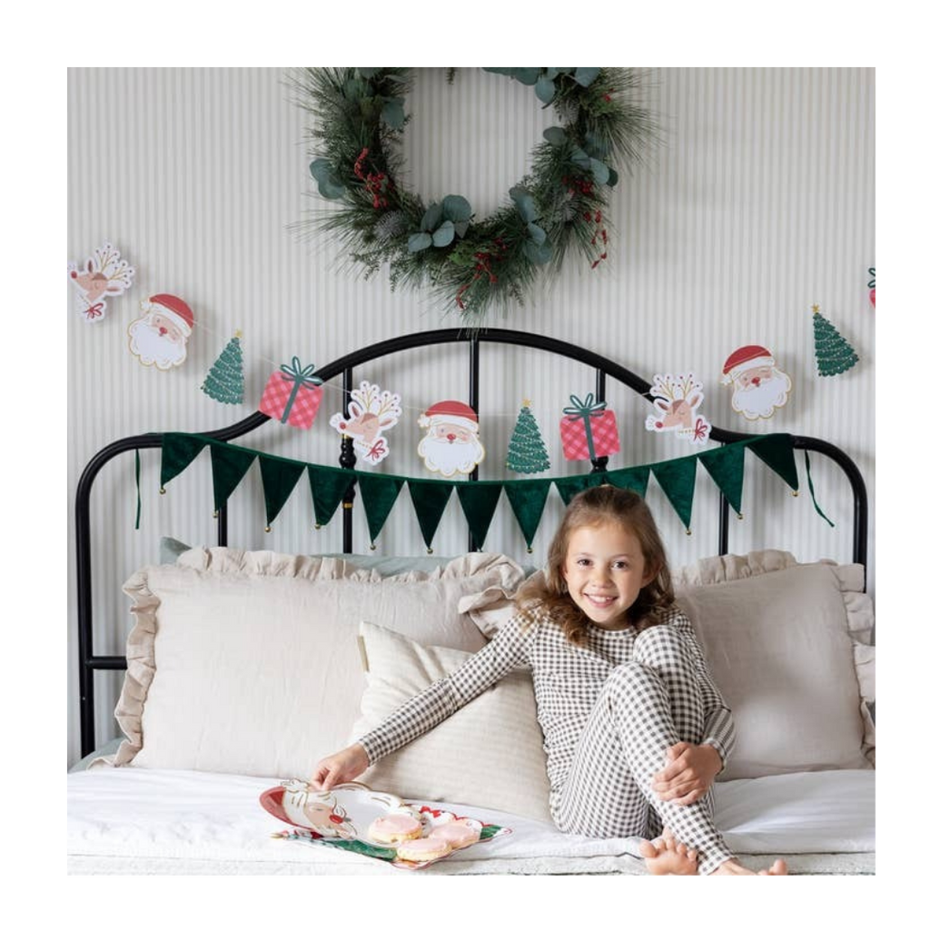Green Christmas garland with Santa and tree shaped paper banner festive holiday decor from Parte Haus party supply store in Bethesda Maryland