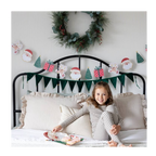 Green Christmas garland with Santa and tree shaped paper banner festive holiday decor from Parte Haus party supply store in Bethesda Maryland