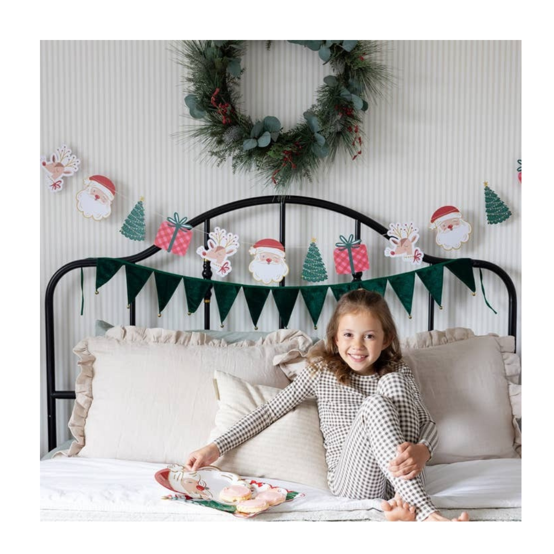 Green Christmas garland with Santa and tree shaped paper banner festive holiday decor from Parte Haus party supply store in Bethesda Maryland