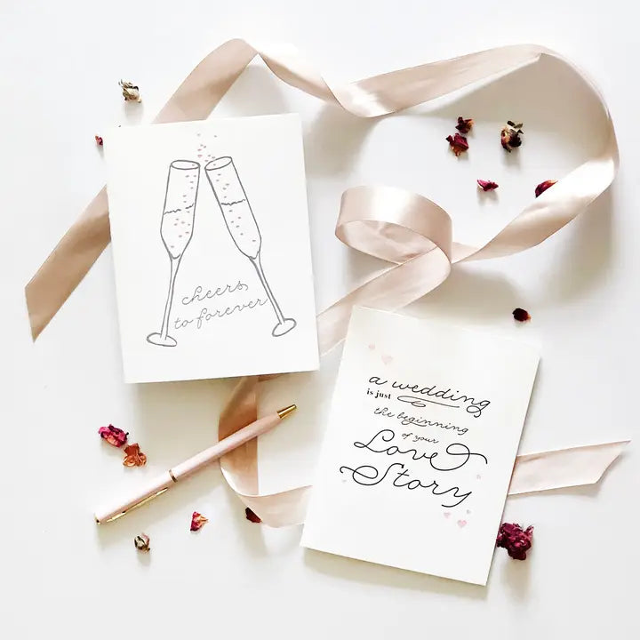 White wedding greeting cards with champagne glasses and romantic text for wedding from Parte Haus party supply store in Bethesda MD.