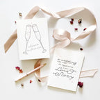 White wedding greeting cards with champagne glasses and romantic text for wedding from Parte Haus party supply store in Bethesda MD.