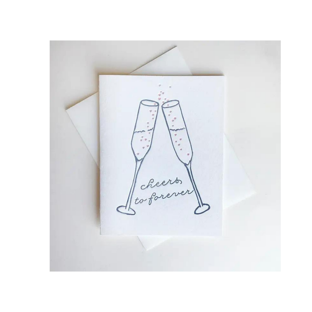 White wedding congratulations card with champagne glasses cheers illustration marriage from Parte Haus party supply store in Bethesda Maryland