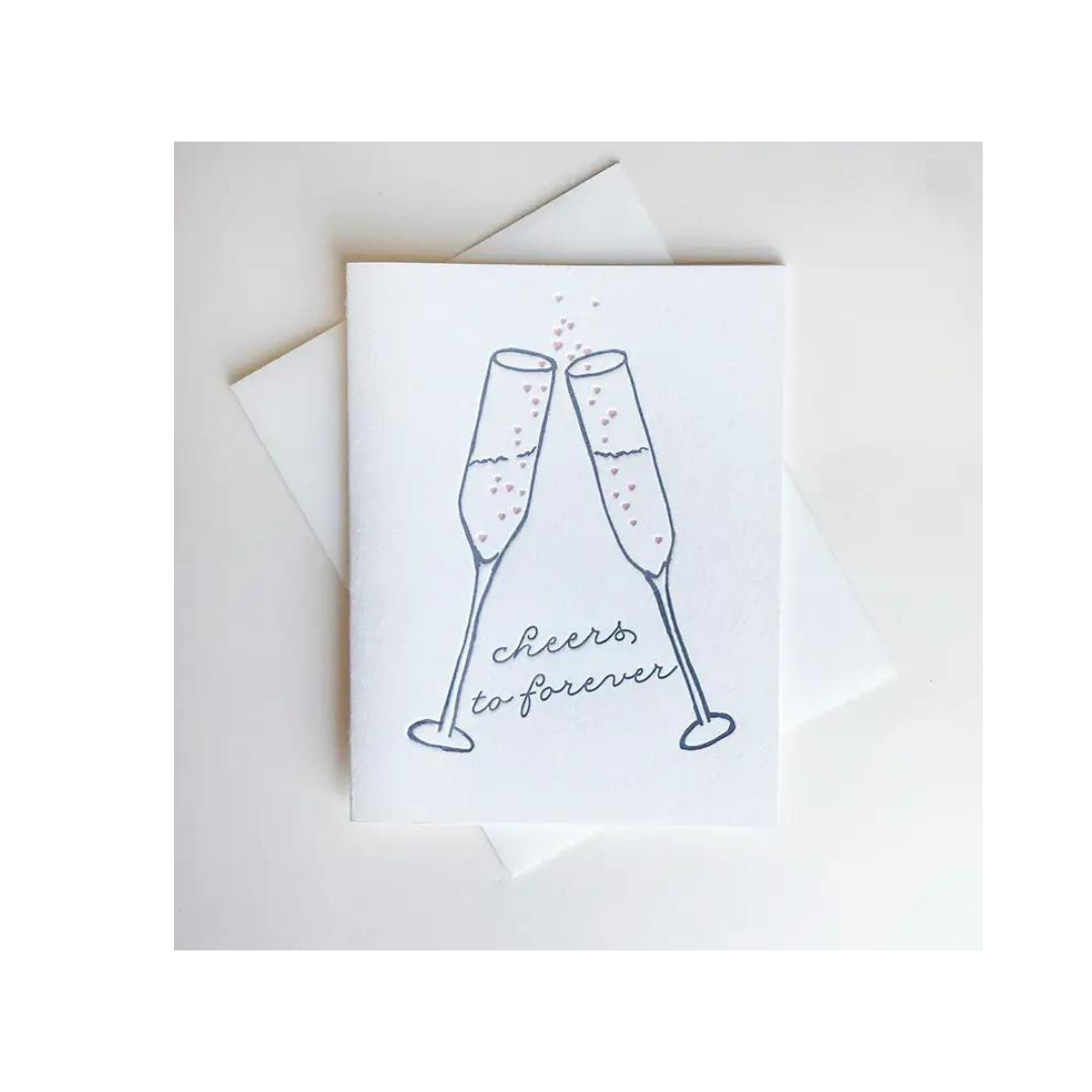White wedding congratulations card with champagne glasses cheers illustration marriage from Parte Haus party supply store in Bethesda Maryland