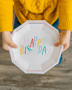 White happy birthday decagon dinner plate with colorful letters birthday theme from Parte Haus party supply store in Bethesda Maryland