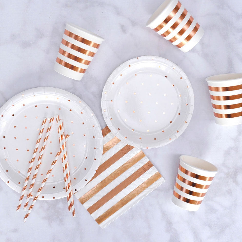 White and rose gold dot dinner plates with matching cups and straws for celebration from Parte Haus party supply store in Bethesda Maryland