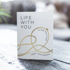 White and gold anniversary card with roller coaster design anniversary theme from Parte Haus party supply store in Bethesda MD