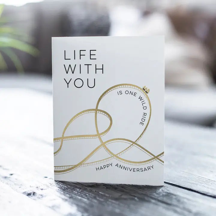 White and gold anniversary card with roller coaster design anniversary theme from Parte Haus party supply store in Bethesda MD
