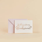 White bridal shower invitation card with gold script and envelope from Parte Haus party supply store in Bethesda MD