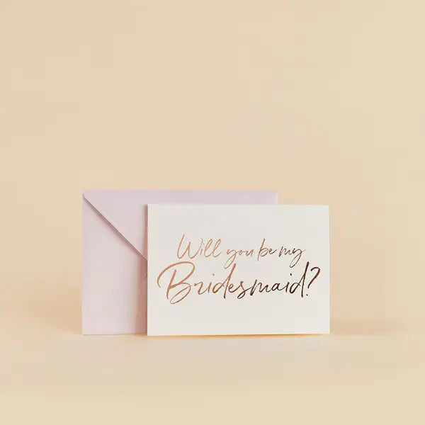 White bridal shower invitation card with gold script and envelope from Parte Haus party supply store in Bethesda MD