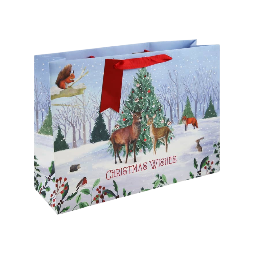 Winter animals Christmas gift bag with red handles festive forest scene from Parte Haus party supply store in Bethesda MD