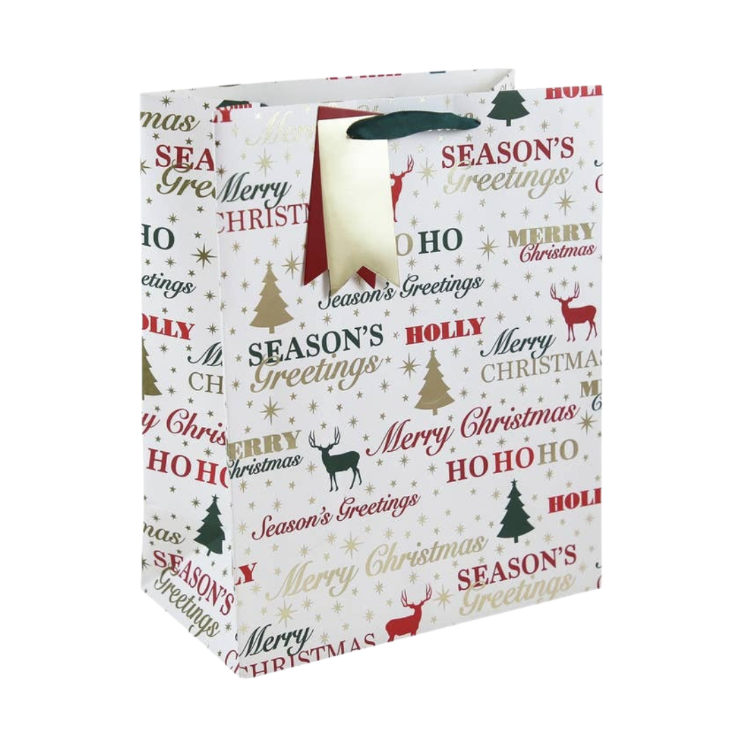 White Christmas gift bag with red and gold festive text and stag from Parte Haus party supply store in Bethesda MD